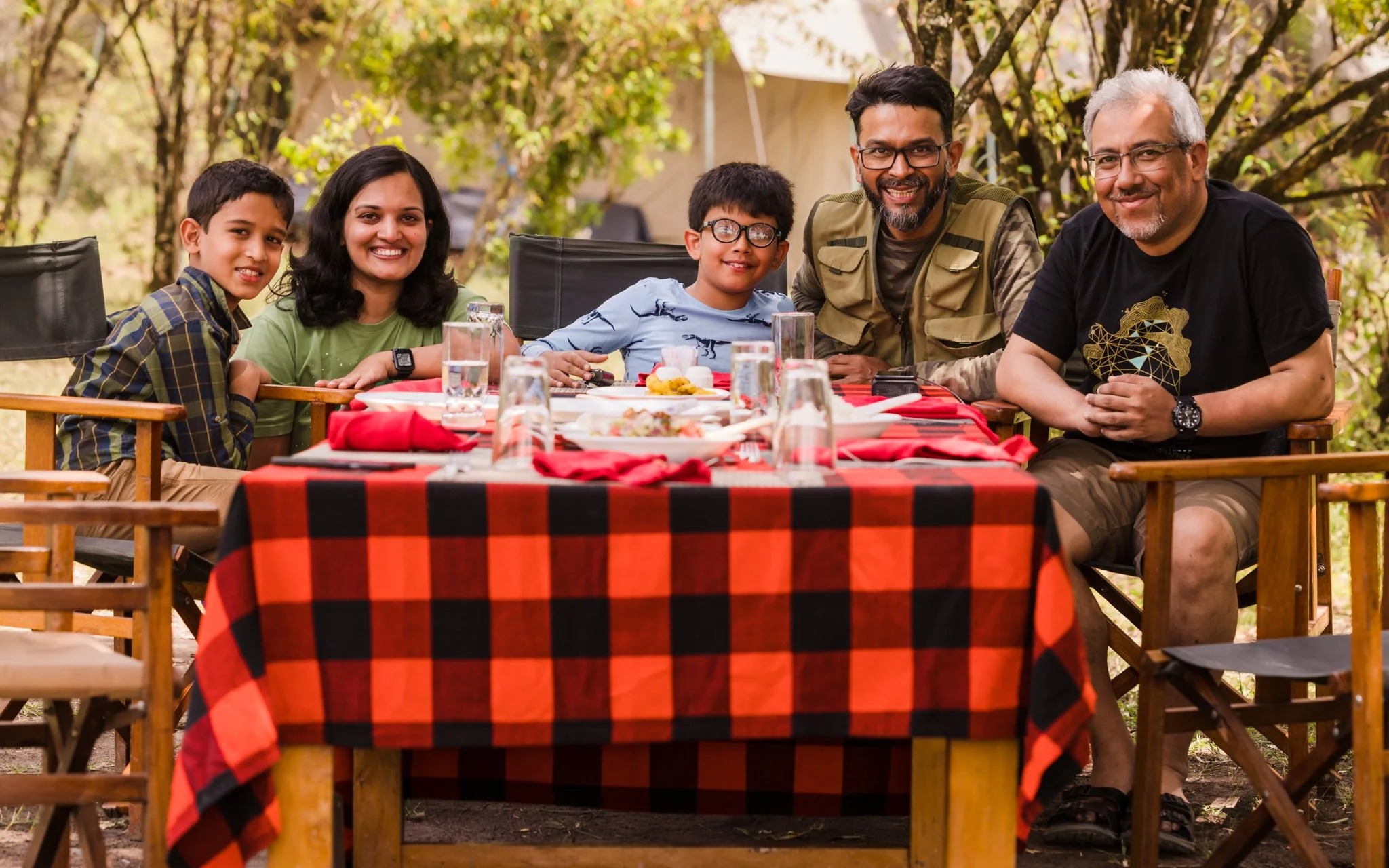 Guests dining together outdoors at Enkoropil Mara Camp
