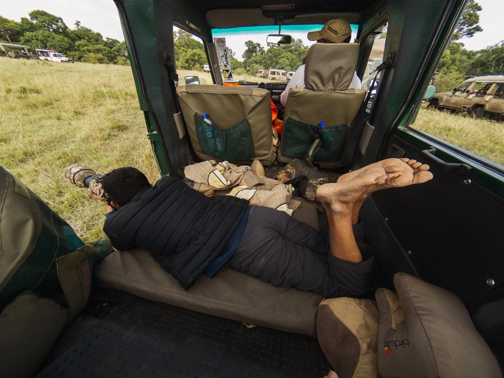 Wildlife photographer using low-angle position in the Enkoropil safari vehicle